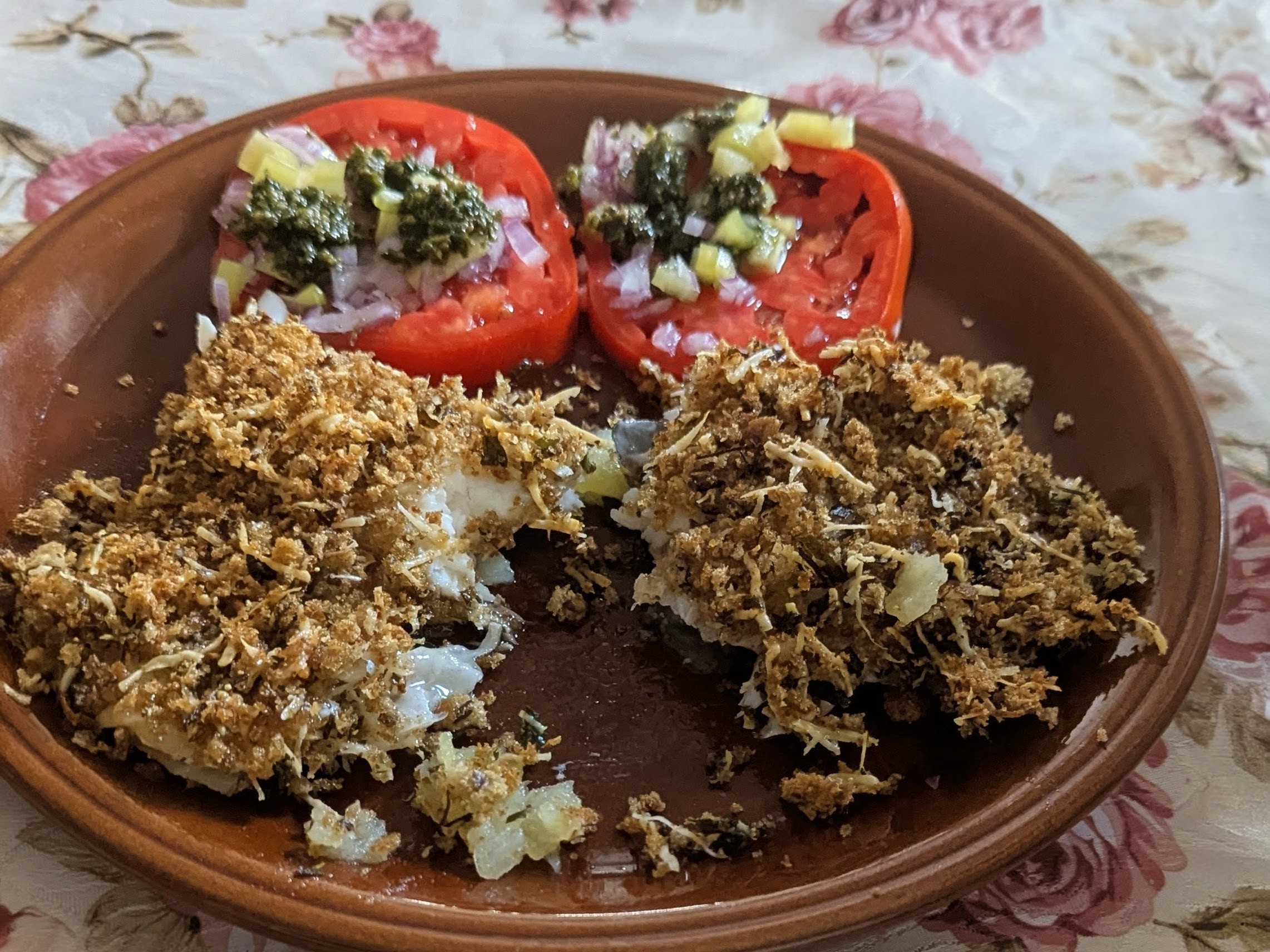 Baked Sea Bream with potatoes in crispy parmesan crust with tomato salad